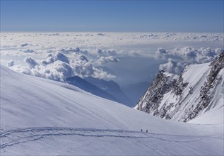 Two climbers above the clouds on Monte Rosa