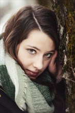 Thoughtful young woman wearing a scarf