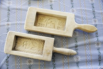 Two wooden butter moulds with carvings