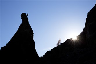 Climber on a cliff in the evening light at Savoy Alps