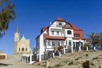 Half-timbered house from German colonial times and rock church in the old town of Luderitz