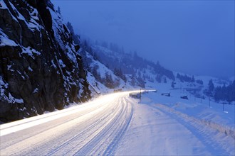 Light trails on a snowy mountain pass