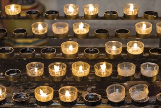 Lighted votive candles in a church