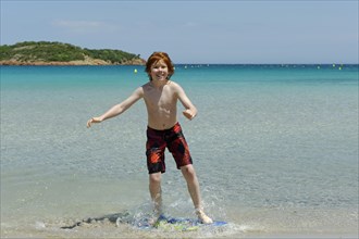 Boy surfing with his boogie board