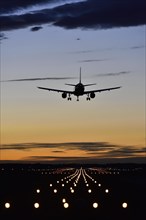 Aircraft landing at sunset