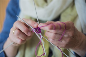 Hands of a senior knitting