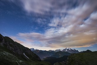 Marmolada glacier in a starry night with clouds