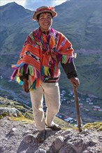 Indio mountain guide with hat and poncho in the Andes
