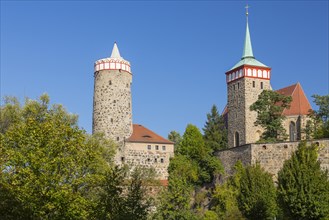 City walls near the Spree river with the tower of the Old Waterworks and St Michael's Church
