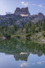 Mount Averau at sunrise reflected in lake Limedes