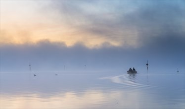 Fishing boat on the mist-shrouded Untersee