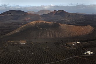 View from the Montana de Guardilama range northwest on the wine growing region of La Geria and the volcanic landscape with volcanic mountains