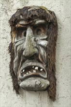 Wooden mask hanging on a wall