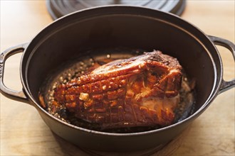 Roast pork with crust in a cast iron casserole