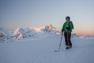 Ski tourer on the summit of Mt Col de Lasta in the Fanes-Sennes-Prags Nature Park in the Dolomites