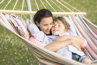 Mother and son lying in hammocks