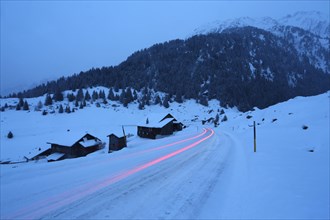 Light trails on the snow-covered Lukmanierpass