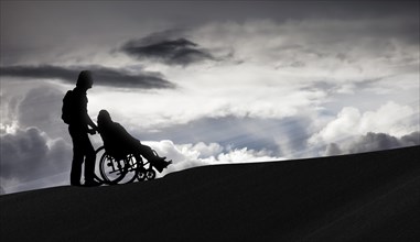 Person pushing a wheelchair