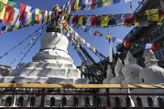 Stupa with prayer flags and prayer wheels