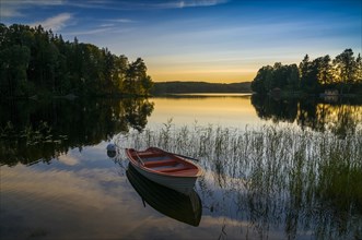 Lake and rowing boat at sunset in Bengtsfors
