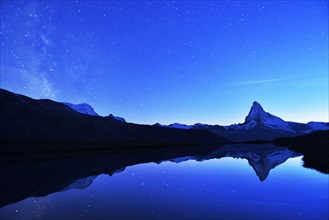 Matterhorn with Milky Way reflected in lake Stellisee