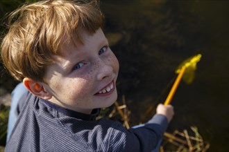 Boy on a lake with fishing net