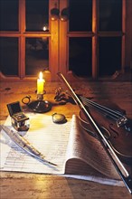 Violin on a music sheet with inkwell and quill