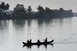 Woman taking children to school in a small boat