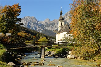 Parish church St. Sebastian in autumn with Ramsauer Ache