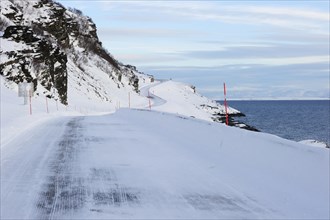 The snow-covered main road E69 on Porsangerfjord