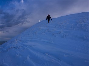 Hiker in snow on Monte Catria