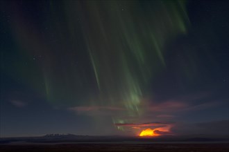 Northern lights and night-time glow of the Holuhraun fissure eruption north of the volcano Baroarbunga