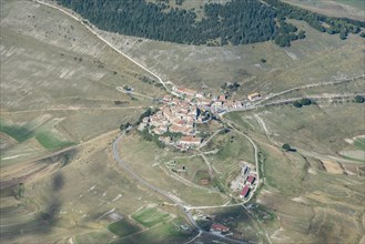 Aerial view of Piano Grande plateau and village of Castelluccio di Norcia