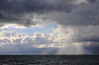 Storm clouds and sunbeams above Lake Geneva
