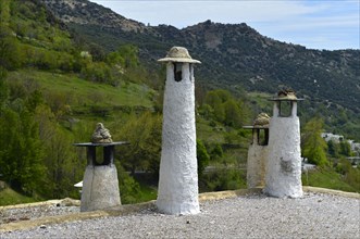 Traditional chimneys on the roofs of Capileira