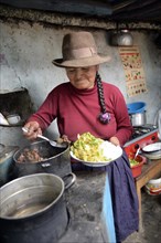 Woman serving a traditional dish with guinea pig meat or Cuy