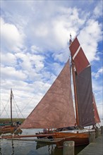 Zeesen boat with set sails in the harbour of Ahrenshoop