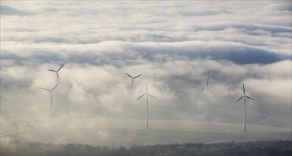 Wind power plants surrounded by clouds