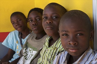 Namibian boys sitting against a wall