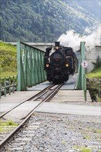Bregenz Forest Railway with steam locomotive crossing steel bridge