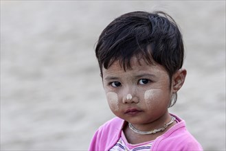 Girl with Thanaka paste on her face