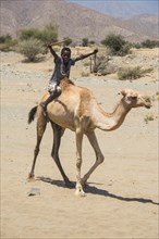 Boy riding on a camel