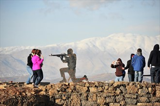 Figure of a soldier and people on the Golan Heights with view of Mount Bental
