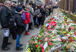 Flowers and flags to commemorate the victim of the terrorist attack that killed a man at Copenhagen's main synagogue on 15 February 2015