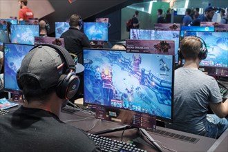 Visitors play video games at Gamescom