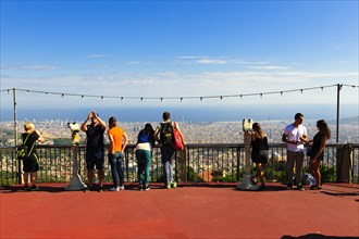 Tourists overlooking the city from Tibidabo Amusement Park
