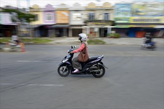 Woman on moped
