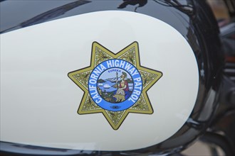 Logo of the California Highway Patrol on a tank of a Harley-Davidson Road King Police FLHP