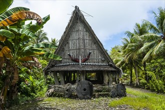 Traditional house with stone money in front