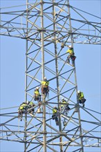 Overhead linemen working on a pylon